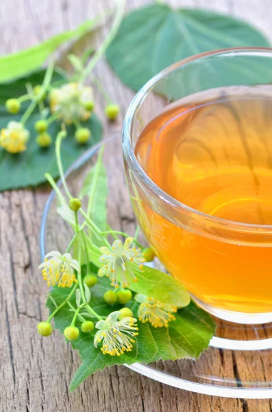 Cup with linden tea and flowers — Stock Photo, Image