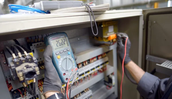 Técnico que testa um painel de controle — Fotografia de Stock