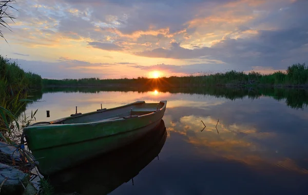 Fisherman boat at sunset time — Stock Photo, Image