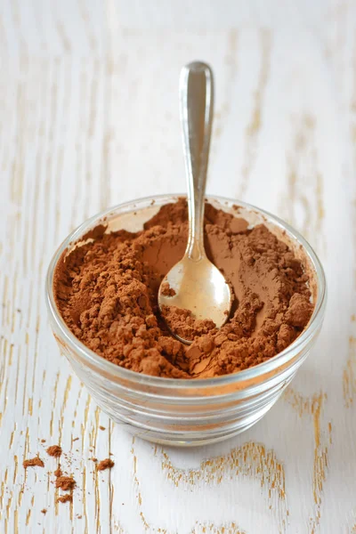 Cocoa powder with a spoon — Stock Photo, Image