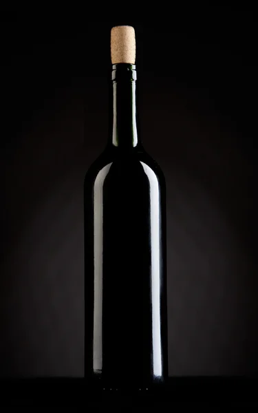 Wine bottle on a dark background studio shot — Stock Photo, Image