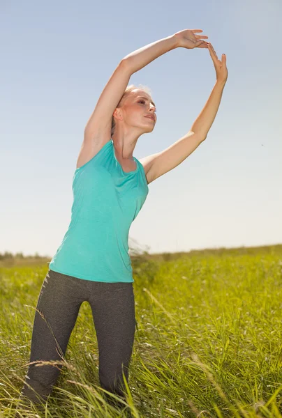 Hermosa joven rubia haciendo ejercicio al aire libre yoga ph — Foto de Stock