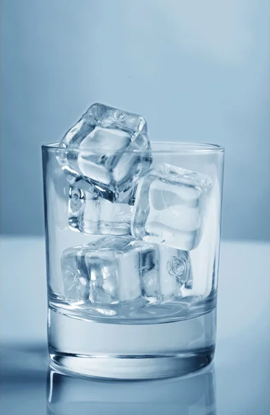 Glass with ice cubes toning photo blue studio shot — Stock Photo, Image