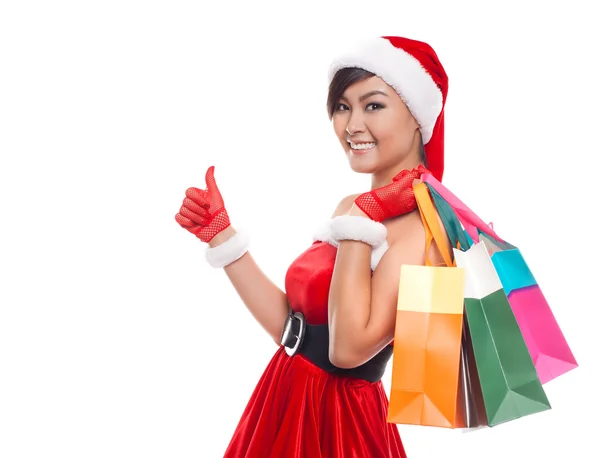 Christmas shopping woman thinking wearing santa hat and holding — Stock Photo, Image