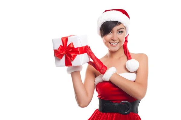 Young woman with Santa hat holding Christmas gift against white — Stock Photo, Image