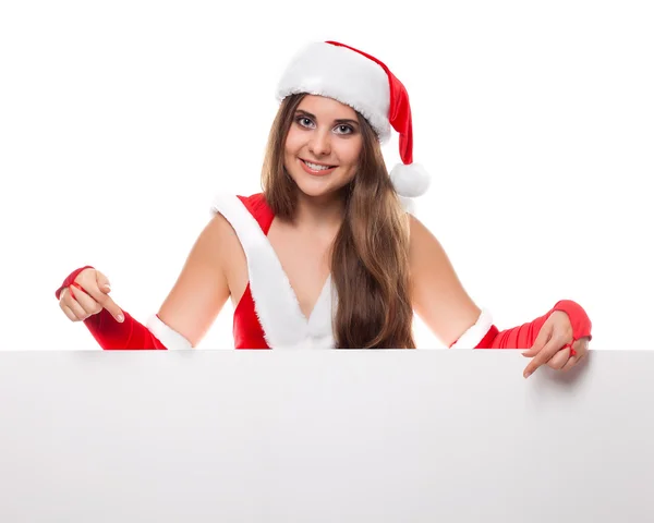 女人在圣诞节衣服和帽子与空的广告牌，白色 — 图库照片