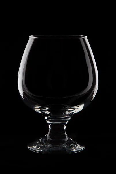 Cognaci puste szkło na czarnym tle łapka — Zdjęcie stockowe
