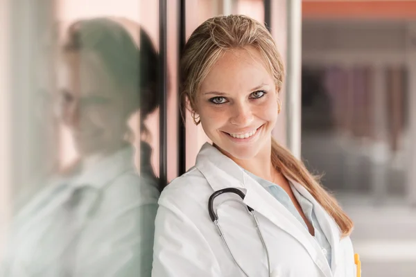 Female doctor next to glass wall — Stock Photo, Image