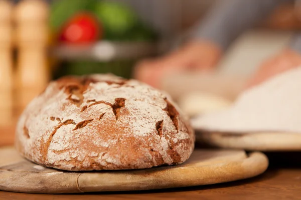 Fresh home made bread over wooden table — Stock Photo, Image