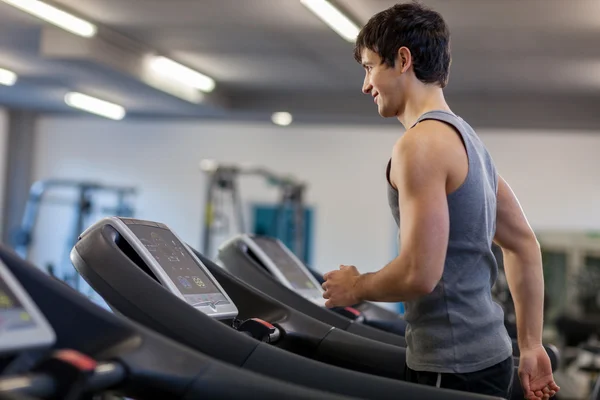 Trained man is running on a treadmill — Stock Photo, Image