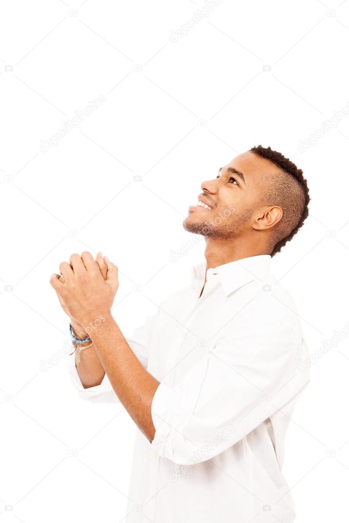 African man is praying on the floor over white isolated backgrou