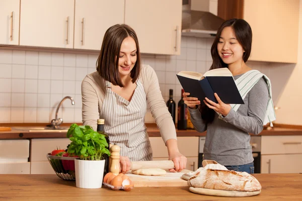 Woman is working on a dough with friend — Stock Photo, Image