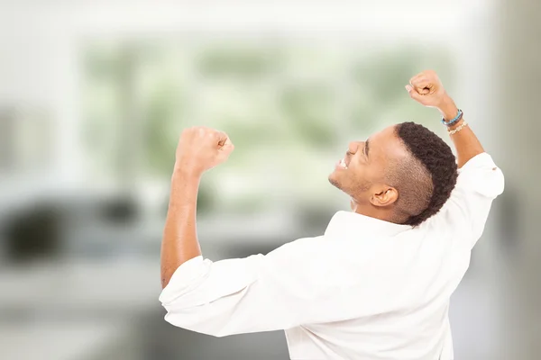 Happy african man is making fist and smiling — Stock Photo, Image