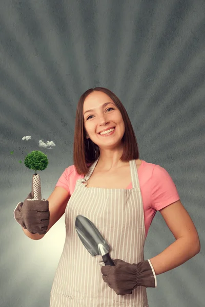 Smiling woman with green thumb — Stock Photo, Image