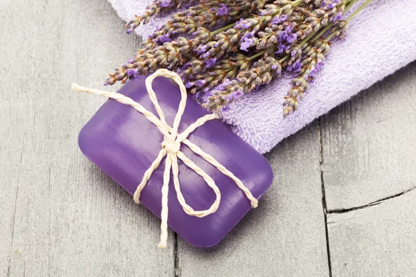 Lavender soap over wooden table — Stok fotoğraf