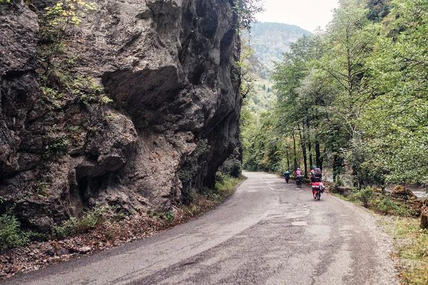 Group of Cycling tourist  trekking the rocky gorge in caucasus m — Stock Photo, Image