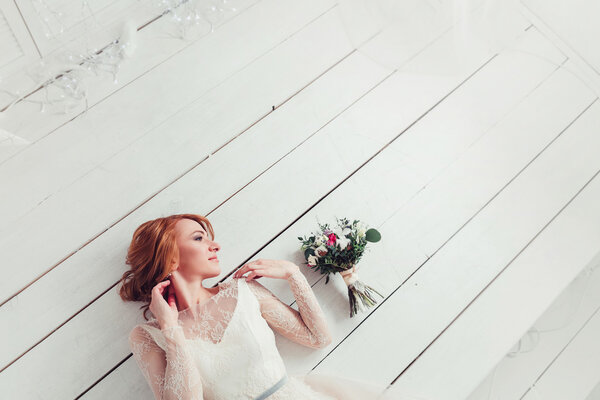 Bride lying on the floor of the whiteboard with copy space
