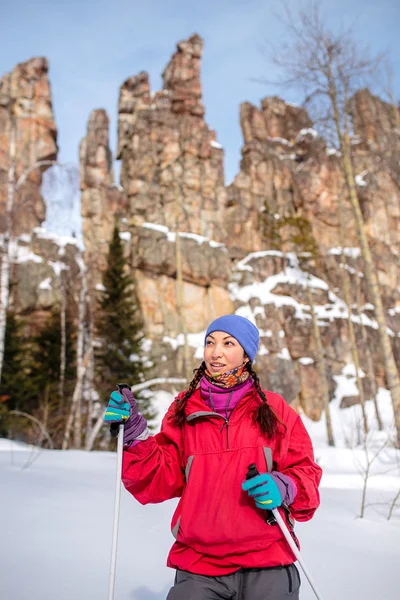 Lány turisztikai télen, háttérben a vörös sziklák, Ural a ruhát hegyi — Stock Fotó