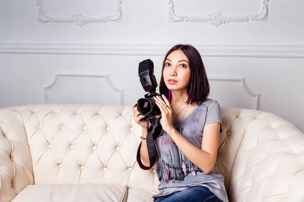 Porträt einer lächelnden jungen Frau mit DSLR-Fotokamera in Dachgeschosswohnung — Stockfoto