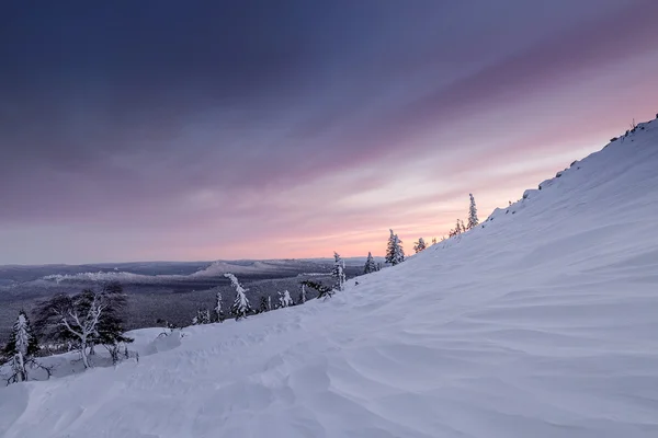 The mountain slope with stones are covered by snow in the winter — Stock Photo, Image