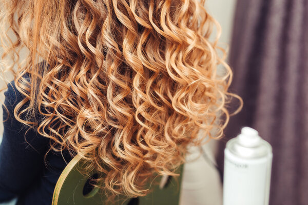 close-up of curly blond hair in barber beauty salon