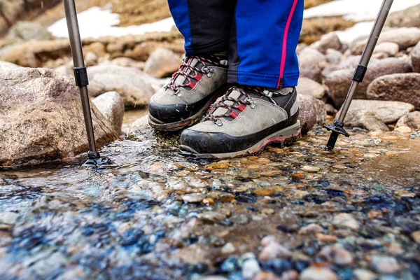 Wodoodporne buty trekingowe wade skalista góra strumienia. Pojęcie wysokiej jakości sprzęt piesze wycieczki — Zdjęcie stockowe