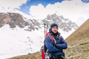 Erkek kış dağlar mavi gökyüzü ufukta trekking kutup ile seyir karşı uzun yürüyüşe çıkan kimse.