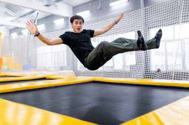 A young man trampolining in fly park clipart