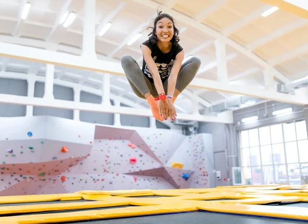 Happy funny brunette jumping on trampoline — Stock Photo, Image