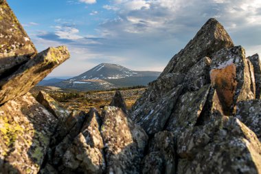 Top of the Iremel mountain by rays of the rising sun. South Ural clipart