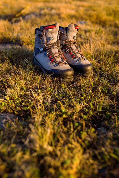 Botas de caminhada na luz do sol nas montanhas — Fotografia de Stock