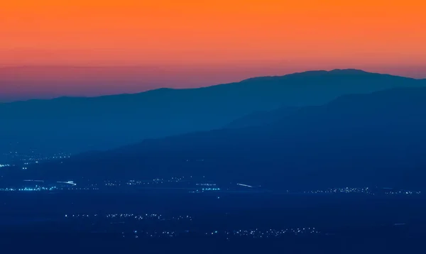 Sun is setting behind big mountain silhoutte