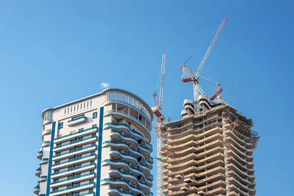 construction of a skyscraper in Dubai and the United Arab Emirates. Concept of real estate and working conditions of employees