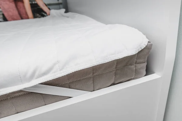 Bed sheet on a modern anatomical and orthopedic mattress with memory foam filling. Hypoallergenic and eco-friendly fabric