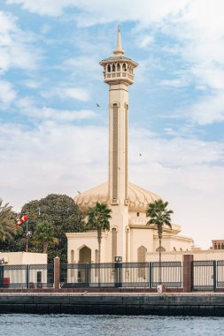 Famous Al Farooq mosque minaret view from Dubai Creek Canal. Tourist and religious destinations in UAE