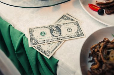 Dollars on the table in restaurant