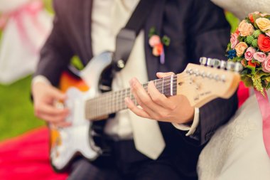 the groom plays guitar clipart