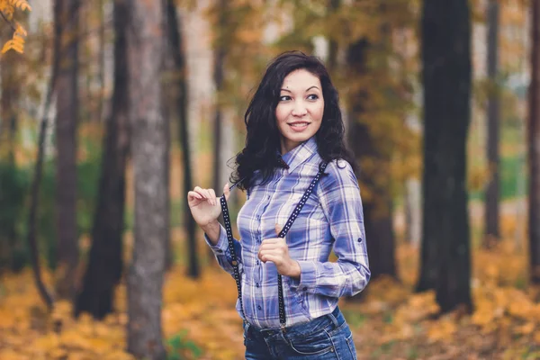 hipster girl with suspenders in autumn park