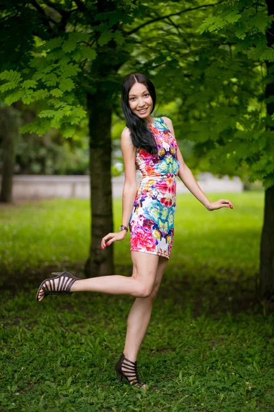 Beautiful young woman in color dress — Stock Photo, Image