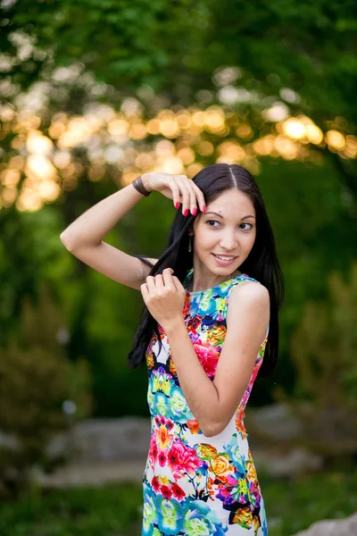 Beautiful young woman in color dress — Stock Photo, Image
