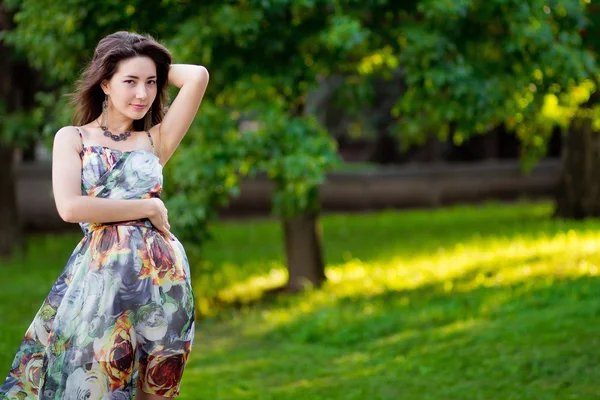 Beautiful sensual woman with long dark hair in dress posing in s — Stock Photo, Image