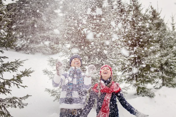 Jovem mulher e homem brincando com neve — Fotografia de Stock