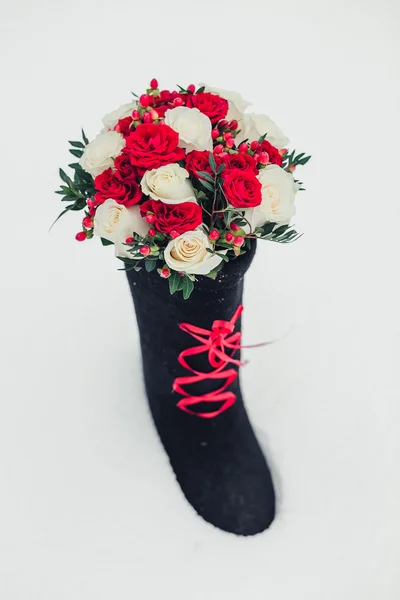 Wedding bouquet and felt boots on white — Stock Photo, Image