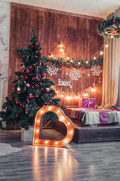 Studio interior with Christmas tree and illuminated heart