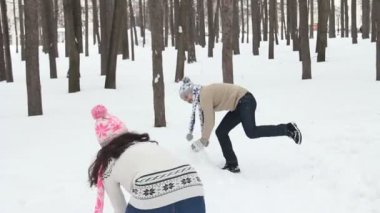 Genç çift bir kartopu sahip bir kar alanda mücadele