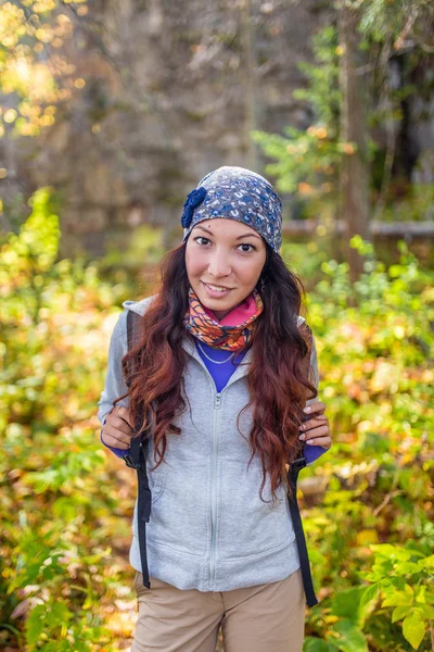 Hiker woman. Hiking portrait of happy young female hiker smiling