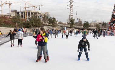 KYIV, UKRAINE - 27 Aralık 2020: buz pateni insanları. İnsanlar buz pateni sahasında eğleniyor. Kyiv 'de yeni yıl tatili.