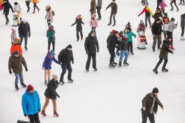 KYIV, UKRAINE - 27 Aralık 2020: buz pateni insanları. İnsanlar buz pateni sahasında eğleniyor. Kyiv 'de yeni yıl tatili.