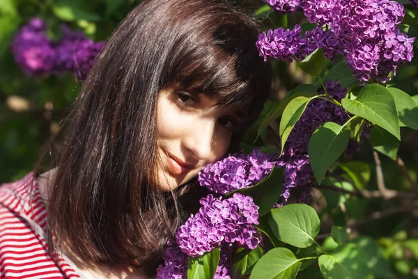 라일락 사이에서 포즈를 취하는 아름다운 여성의 꽃피는 라일락 여자들 — 스톡 사진
