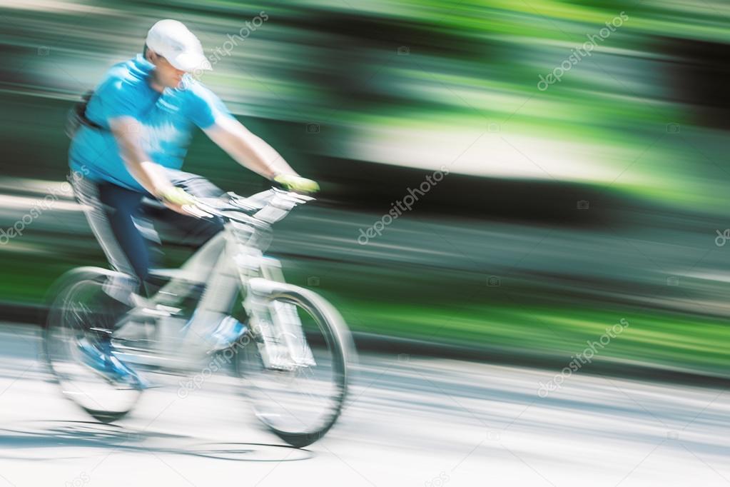 cyclist in traffic on the city roadway